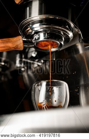 Coffee Machine Pouring Espresso In Double Wall Glass From Bottomless Naked Portafilter.