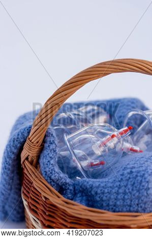 Jars for hijama in a basket in the snow. Wicker basket. Bloodletting according to the Sunnah. Vacuum