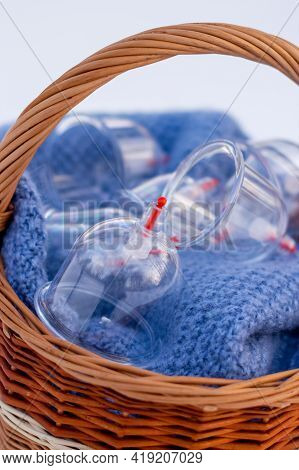 Jars for hijama in a basket in the snow. Wicker basket. Bloodletting according to the Sunnah. Vacuum