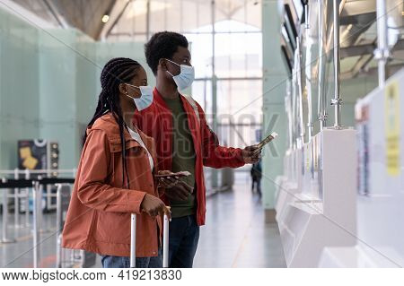 Couple Of Travelers In Protective Mask At Checkin Counter In Airport Before Flight In Coronavirus Ep