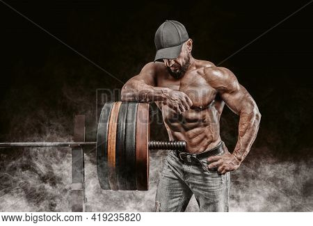 Muscular Bearded Man Stands Near The Barbell. Bodybuilding, Fitness, Powerlifting Concept.