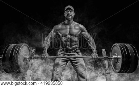 Muscular Bearded Man Lifts A Barbell. Bodybuilding, Fitness, Powerlifting Concept.