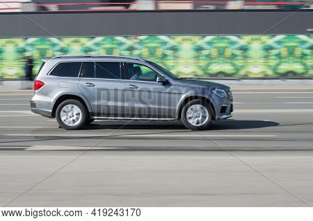 Mercedes Gl Crossover In The City Road. Fast Moving Silver Suv Car On The Street With Blurred Backgr