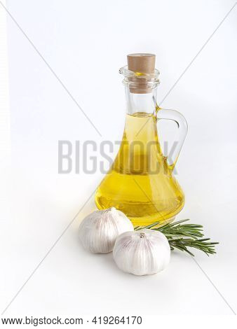 Rosemary Twig And Garlic, Olive Oil On Bottle Isolated On White Background.