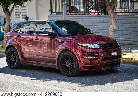 Alanya, Turkey - April 17 2021:  Red Range Rover Evoque   Is Parked  On The Street On A Warm Summer 