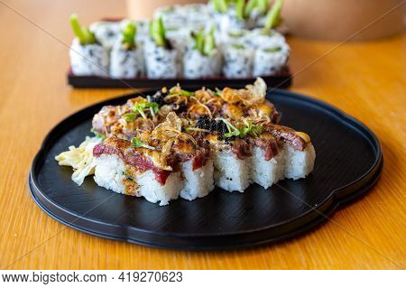 Japanese Aburi Wagyu Beef Sushi Flame-seared With Flying Fish Egg Roe And Topped With Crab Miso Sauc