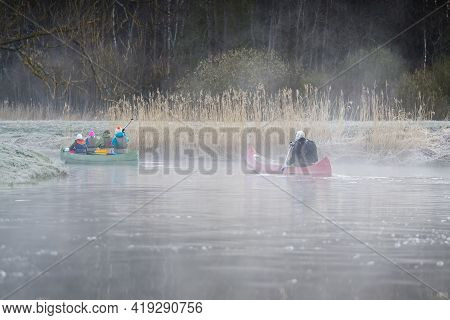 Man Rowing A Canoe In Early Spring In The Early Morning. Lifestyle. Morning Landscape, Fog By The Mo