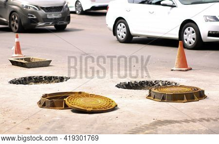 Replacement Of Sewer Hatches On The Asphalt Of The Road, Repair Work On The Carriageway. Fencing Wit