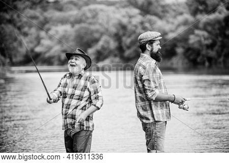 Good Days. Two Happy Fisherman With Fishing Rod And Net. Father And Son Fishing. Hobby And Sport Act