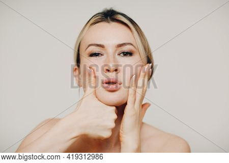 Young Adult Woman Doing Facial Gymnastics Self Massage And Rejuvenating Exercises And Face Building 