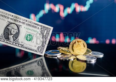 Doge Road To One Dollar. Dogecoin And Other Crypto Coins With One Dollar Banknote On Reflecting Tabl