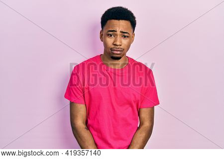 Young african american man wearing casua t shirt depressed and worry for distress, crying angry and afraid. sad expression. 