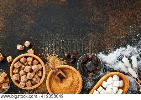 White Sugar, Cane Sugar Cubes, Caramel In Bamboo Bowl On Dark Brown Table Concrete Background. Assor