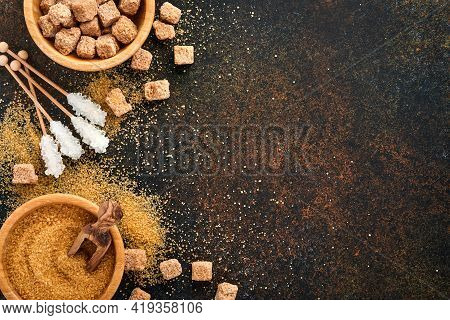 White Sugar, Cane Sugar Cubes, Caramel In Bamboo Bowl On Dark Brown Table Concrete Background. Assor