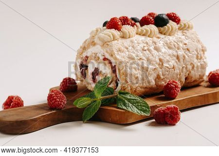 Meringue Roll With A Gentle Airy Cream, Mint And Fruit Filling From Raspberries, Black Currants, Blu