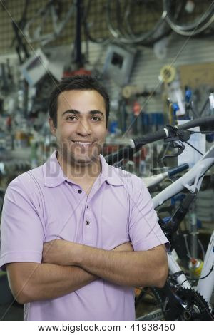 Portrét jistý shop chovatel s rukama zkříženýma stojí v obchodě