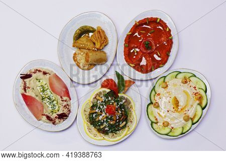 Libanese Food Mezze, Arabic Food Includes Hummus, Muhammara, Moutabal, Taboule And Vine Leaves