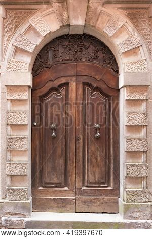 Beautiful Front Door. Carved Door With Metal Forging. Entrance To One Of The Old Houses In Barga.