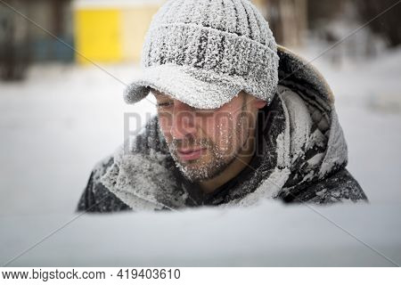 Portrait Of A Worker In A Black Cap