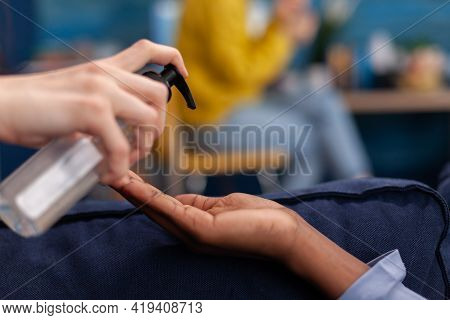 Multi Ethnic Friends Using Hand Gel To Prevent Coronavirus Infection