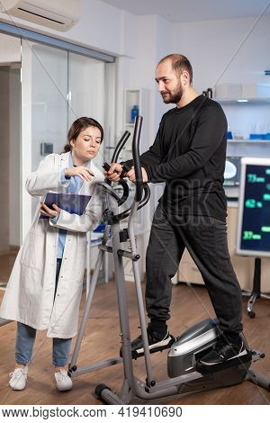 Athlete Running On Cross Trainer In Sport Science Laboratory