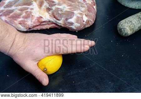 Homemade Capicola (coppa). Dry-cured Pork Loin Step-by-step Recipe. A Hand Presses A Ripe Whole Lemo
