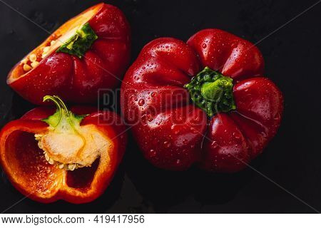 Fresh Red Bell Pepper On Black Background. Top View Tropical Abstract Background. Cloe Up Pepper Veg