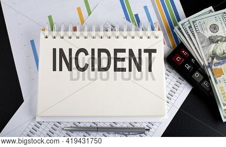 Incident Text Written On The Notebook With Chart,calculator And Dollars