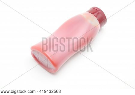 White Bottle With Red Food Product On White Background