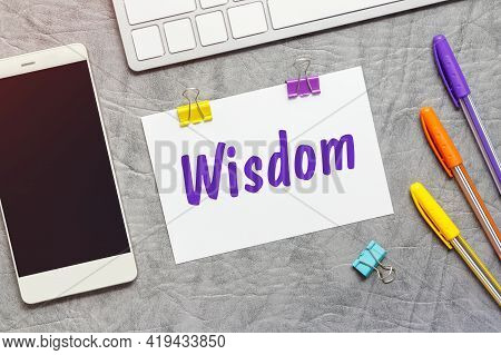 A Paper Note With The Text Of The Wisdom, Keyboard And A Smartphone.
