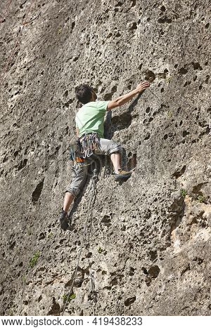 Climber On A Granite Wall. Extreme Sport. Outdoor Mountain Activity
