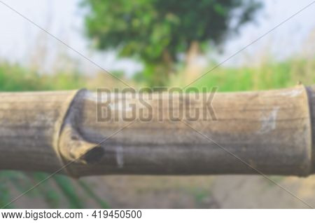 Blurred Images Of Bamboo Pieces Laid Across Concrete Channels And Grasslands In The Evening Of The D