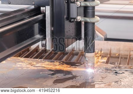 Automatic Cnc Plasma Cutting Machine Working With Sheet Metal With Sparks At Factory, Plant. Metalwo