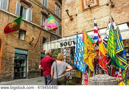 Siena, Italy - Circa September 2018. Flags Of The Siena Contrade (districts) For The Palio Festival.