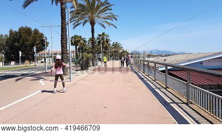 Cagnes-sur-mer, France - 25 April, 2021: People Walking In The Street In The Front Of The Sea. The C