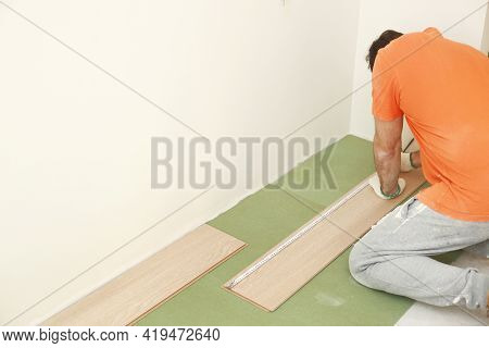 Installation Laminate Or Parquet In The Room, Worker Installing Wooden Laminate Flooring, Marking Th