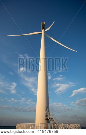 Wind Turbine Genarating Electricity With Blue Sky