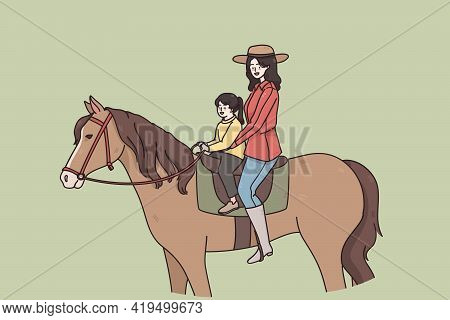 Summer Activities And Riding Concept. Young Smiling Woman Mother And Small Daughter Sitting On Horse