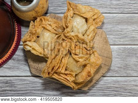 Plate Of Fried Sweet Potato And Quince Pastries. Traditional In The Argentine National Holidays
