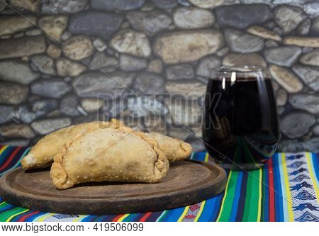 Northern Empanadas, Meat Fries And A Glass Of Red Wine. Argentine Gastronomy