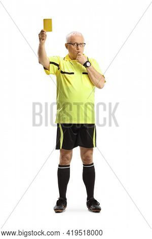 Full length portrait of a football referee showing a yellow card and wistling isolated on white background