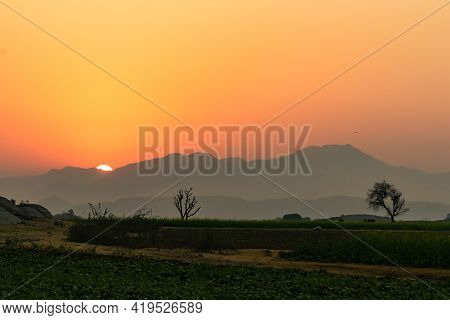 An Image With Dynamic Range Of Sun Rise From Behind The Aravalli Mountain Ranges Seen As Silhouette 