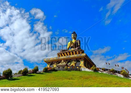 Statue Of Buddha At The Buddha Park With Blue Sky And Clouds In The Background As Seen From Rabongla