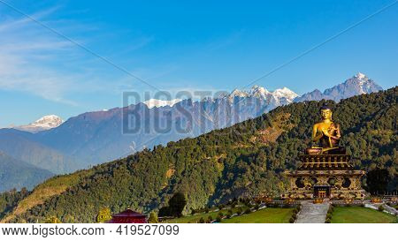 A Selective Focus Image Of Buddha Statue At Buddha Park With Snow Clad Himalayan Mountain Range In T