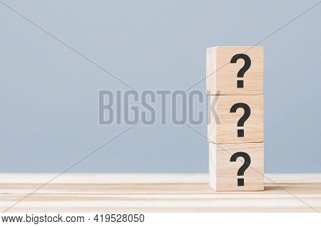 Questions Mark ( ? ) On Wooden Cube Block On Table Background. Faq( Frequency Asked Questions), Answ