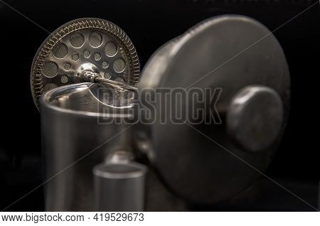 Close-up Of Cafetiere Plunger Is Placed On Stainless Steel Jug  With A Shallow Depth Of Field On Bla