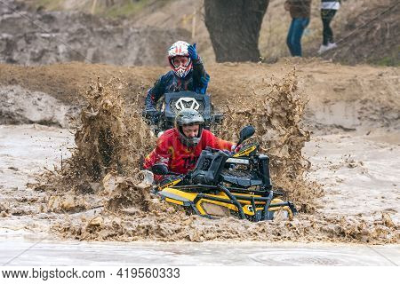 Afipsip, Russia - October 31, 2020: Sportsmen On Quad Bikes Drive Splashing In Dirt And Water At Mud