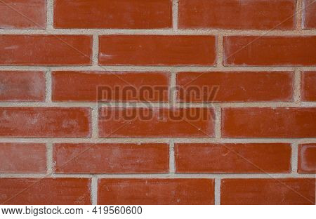 Texture Of An Old Exterior Wall Surface Made Of Red Bricks. Bricks Are Aged And Weathered. Cement Mo