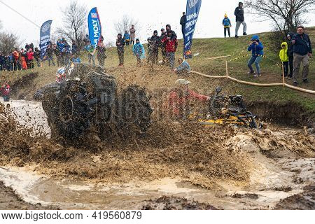Afipsip, Russia - October 31, 2020: Sportsmen On Quad Bikes Drive Splashing In Dirt And Water At Mud