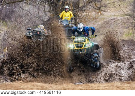 Afipsip, Russia - October 31, 2020: Sportsmen On Quad Bikes Drive Splashing In Dirt And Water At Mud